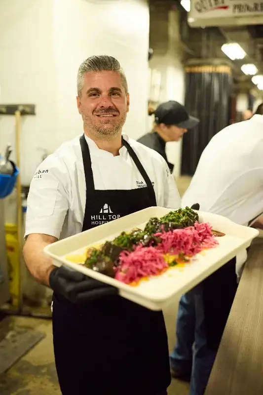 Chef Nick Zocco holding his dish